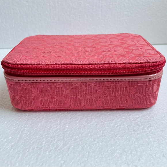 Coach Jewelry - Coach SignatureTravel Jewelry
Box w/zip closure. Lid w/bow and compartments.Pink